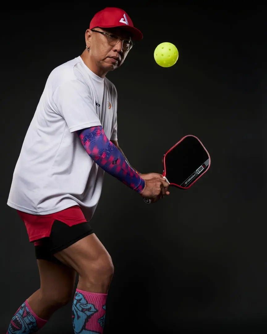 Bari Hsiung, founder of Akademi Kinetiq, striking a pickleball